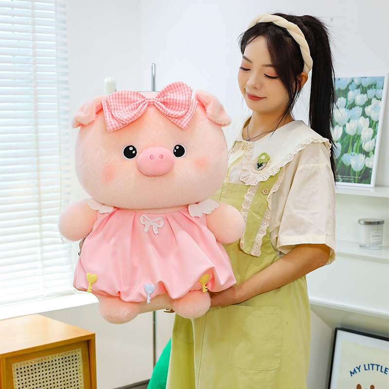 Bubble pig plush toy in pink dress with bow detail, soft plush fabric and rounded shape, suitable for hugging and cozy home decoration