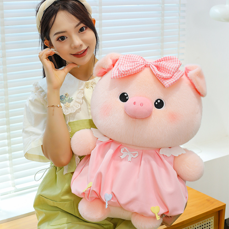 Bubble pig plush toy in pink dress with bow detail shown up close, soft plush fabric and gentle color, ideal for cozy decor and cuddling