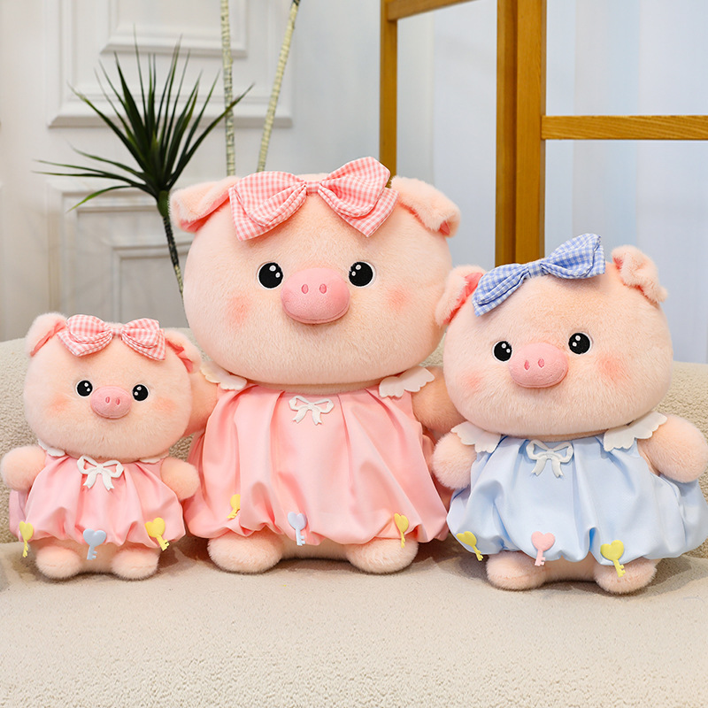 Bubble pig plush toys in pink and blue with bow dresses shown in multiple sizes, soft plush fabric and rounded design, ideal for cuddling, gifting and home decor