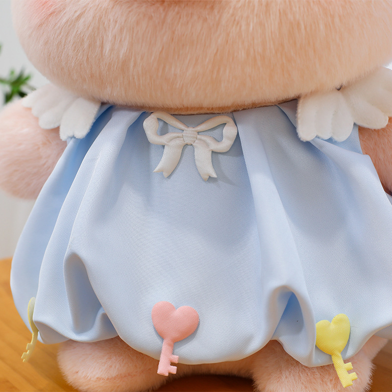 Bubble pig plush toy dress detail in blue fabric with bow and heart key accents, soft texture and neat stitching, designed for a cute and decorative finish