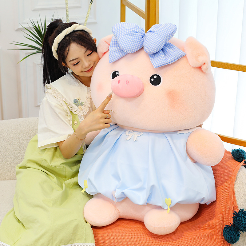 Bubble pig plush toy in blue with bow dress, soft plush material and smooth texture, ideal for cuddling and creating a warm and comforting atmosphere