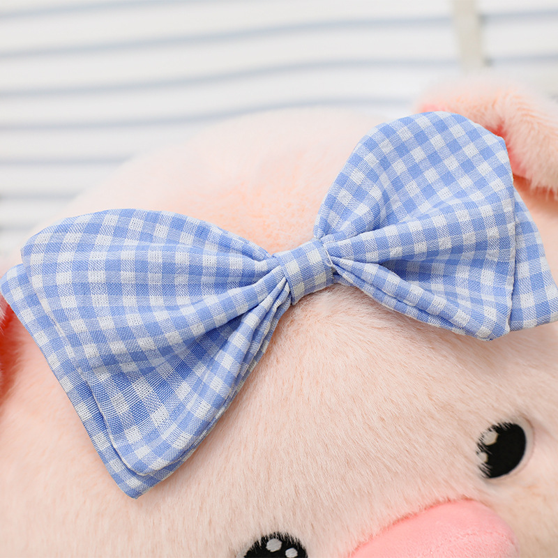 Bubble pig plush toy bow detail in blue gingham fabric, soft material and neatly stitched design, adding a charming and playful touch to the plush