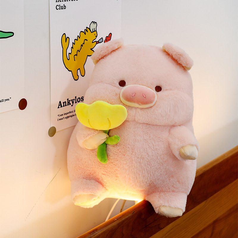 Pig plush toy with yellow flower design soft stuffed animal pillow placed on bedside with soft warm lighting