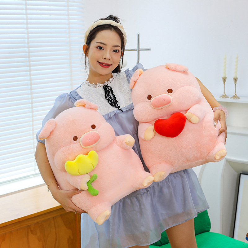Cute pig plush toy with heart and flower designs, soft stuffed animal pillows held and displayed for hugging, relaxing and cozy home decoration