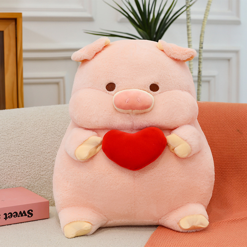 Pig plush toy with red heart design soft stuffed animal pillow placed on sofa in a cozy home setting