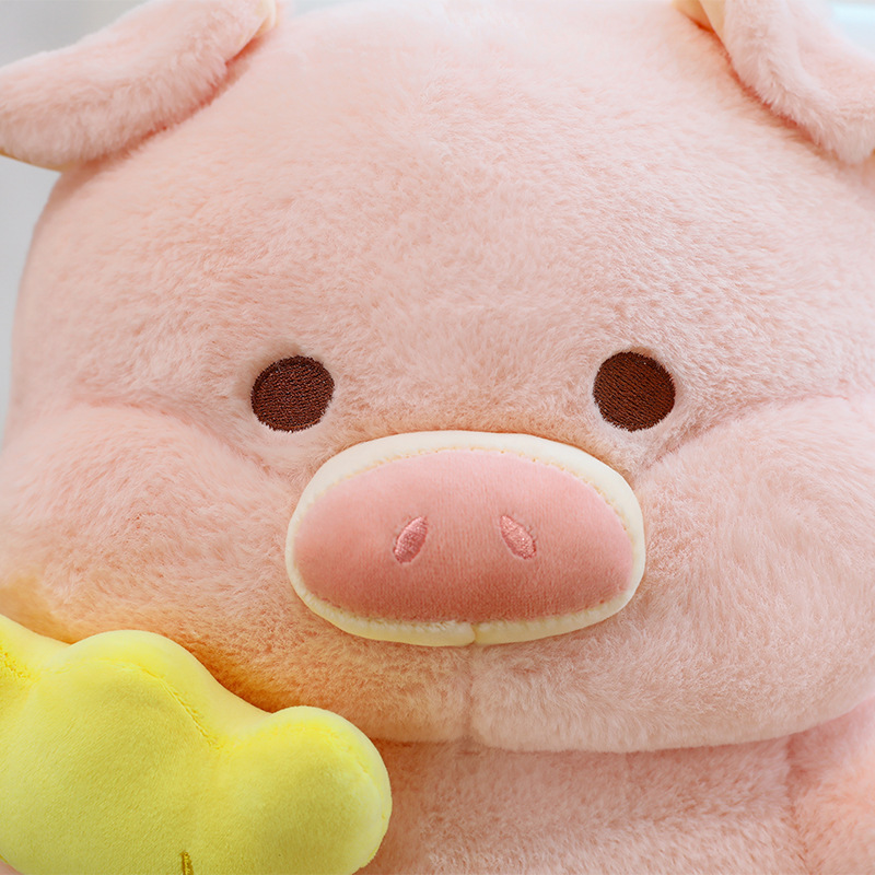 Soft pig plush toy close up showing embroidered eyes, nose details and smooth plush fabric texture