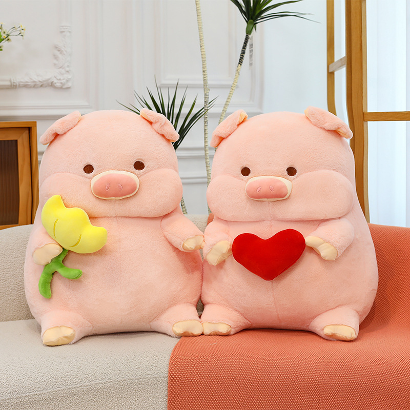 Pig plush toy pillows with heart and flower designs displayed on sofa for cozy home decor and gifting