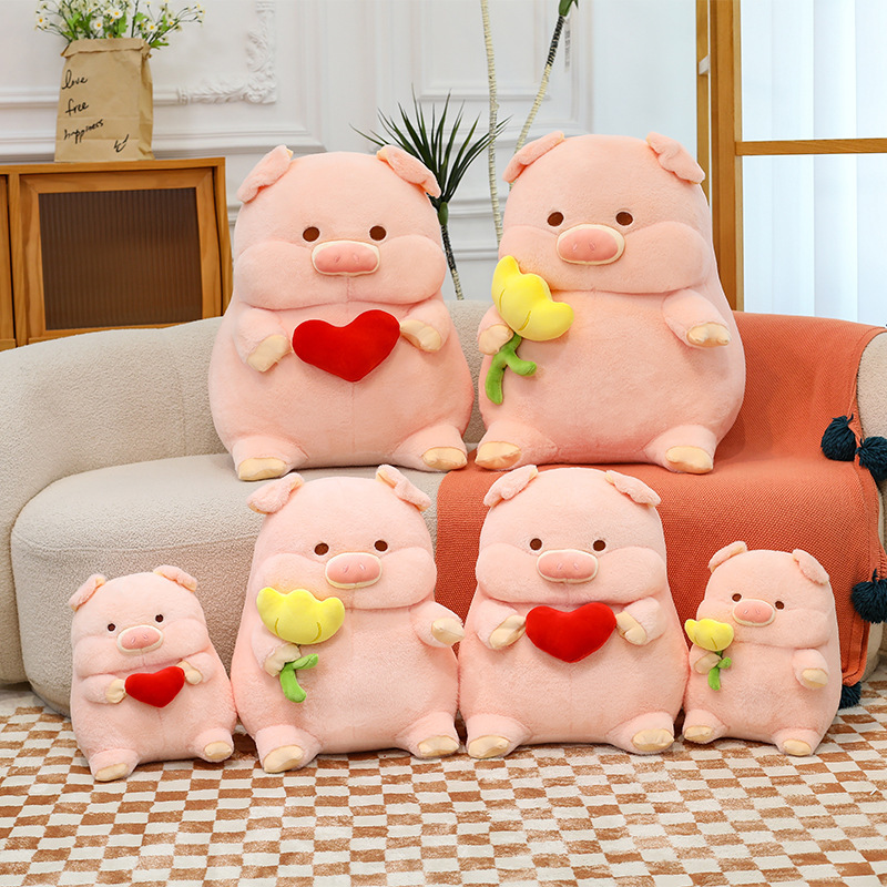 Cute pig plush toy in multiple sizes with heart and flower designs, soft stuffed animal pillows displayed on sofa and floor for home decor