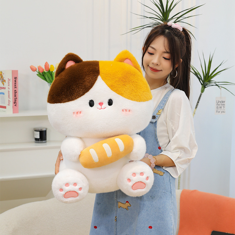 Baguette cat plush toy held in cozy indoor setting featuring soft plush texture cute facial details and comforting hugging experience