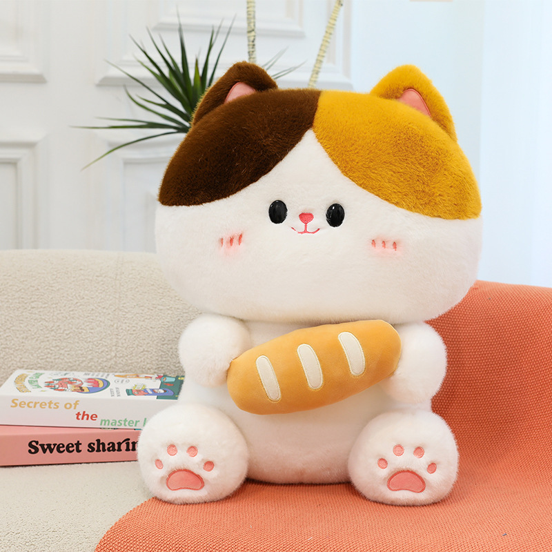 Baguette cat plush toy sitting on sofa featuring soft plush fabric rounded shape and bread design in warm home environment