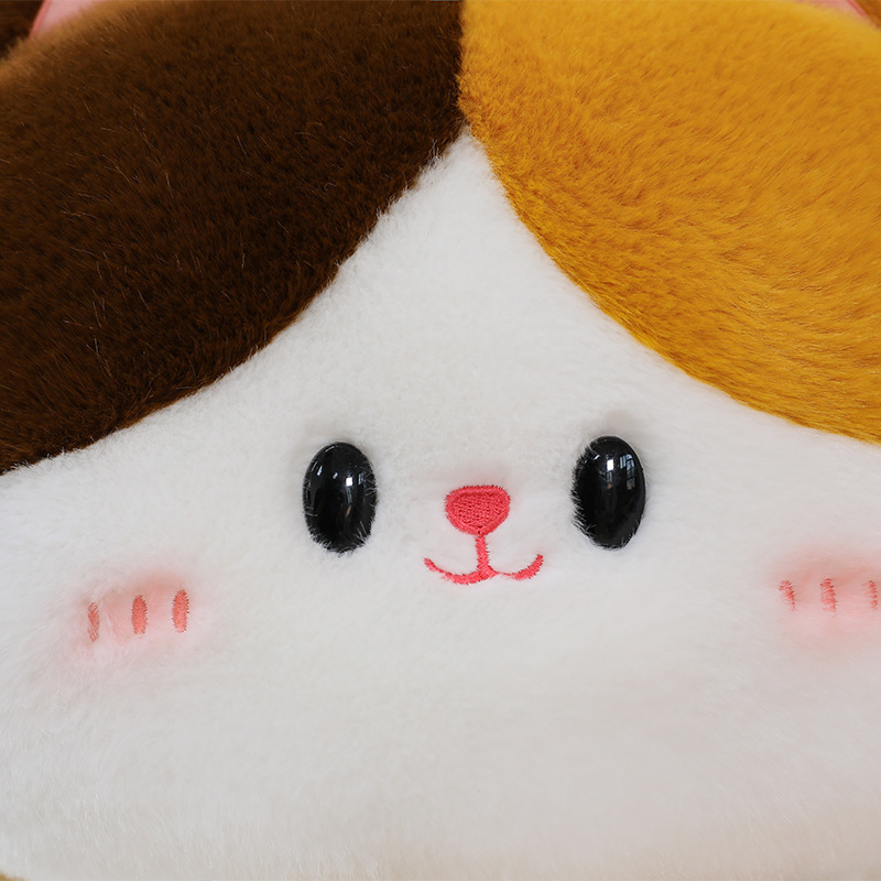 Close up of baguette cat plush toy face highlighting soft plush fabric embroidered details and cute facial expression