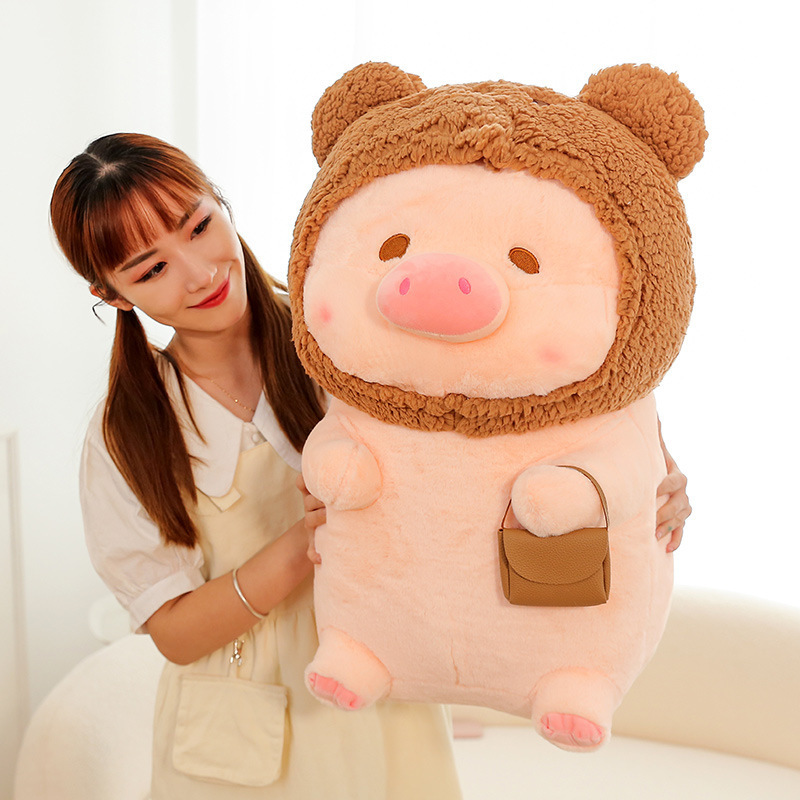 Pig plush toy in bear costume with soft plush fabric and small pouch detail, cute stuffed animal for cuddling, display, or gifting