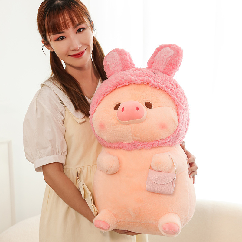 Pig plush toy in rabbit costume with small pouch detail, soft stuffed animal for hugging, decorating, or gifting