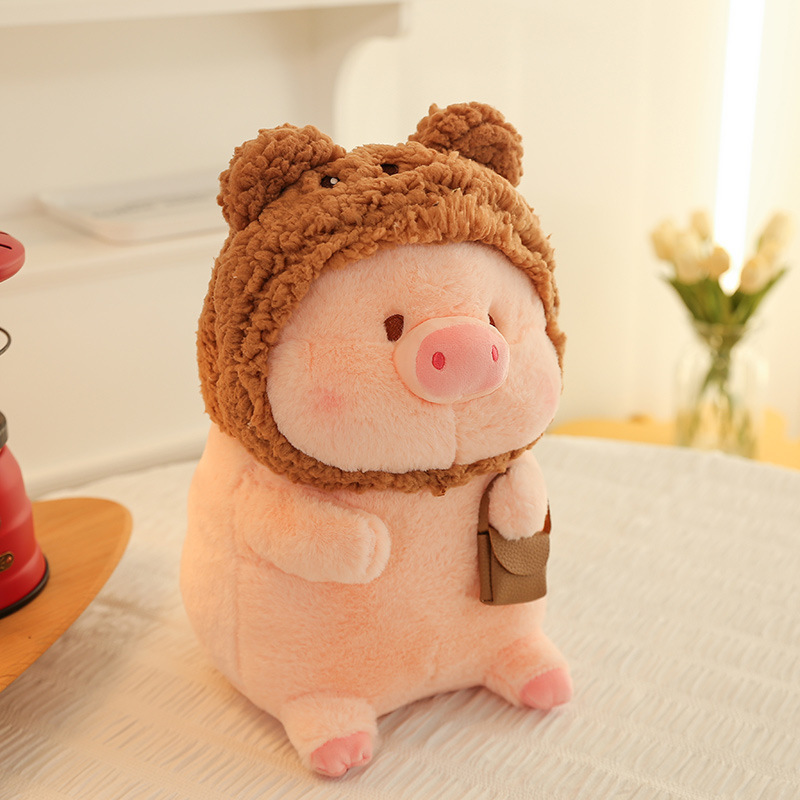 Pig plush toy in bear costume with soft plush fabric and textured hood, placed in a warm indoor setting for decoration and comfort