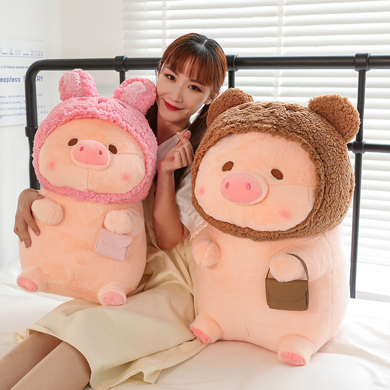 Pig plush toy in animal costume with soft plush fabric and rounded shape, placed in a warm bedroom setting, suitable for hugging and relaxing moments
