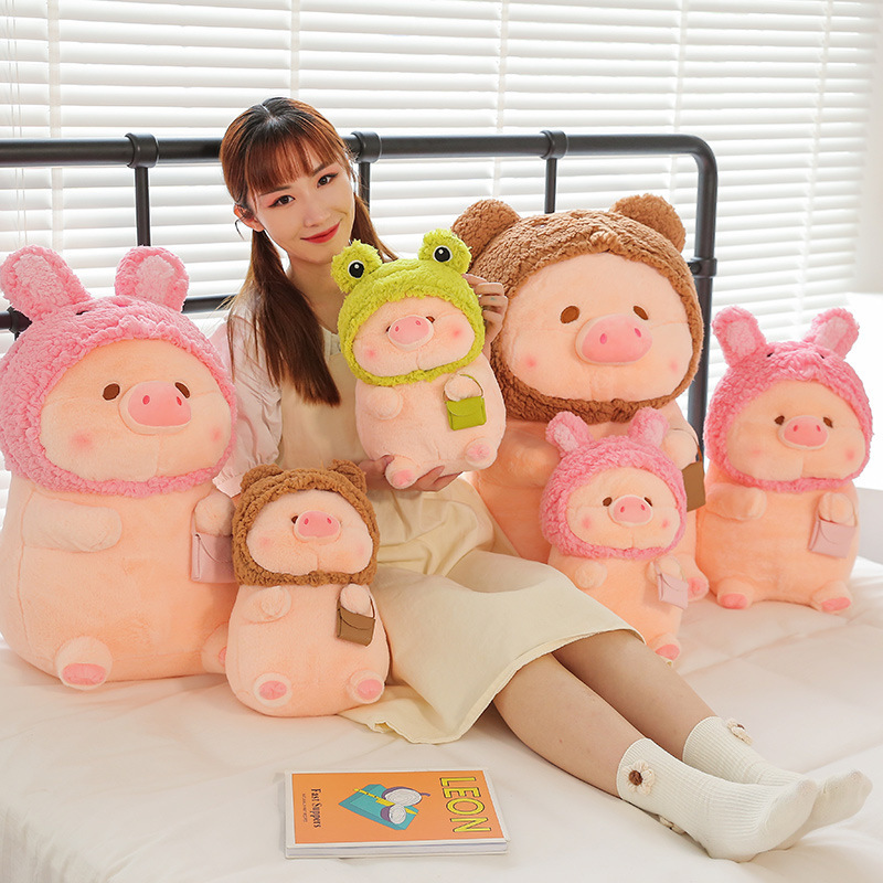 Pig plush toy in animal costume displayed in multiple sizes and styles on a bed setting, featuring soft plush texture and cute designs for cozy spaces and home decor
