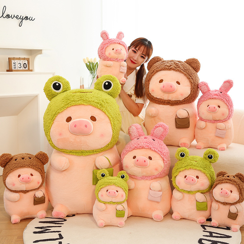 Pig plush toy in animal costume displayed in various sizes and styles, including frog, bear, and rabbit designs, soft stuffed plush for home decor and gifting