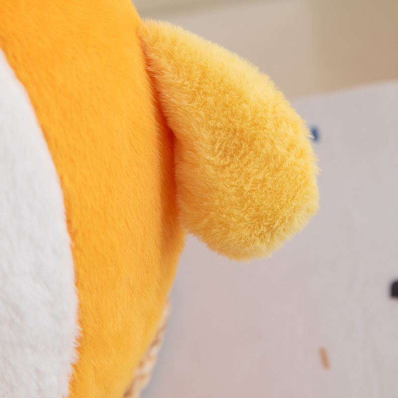 Close-up of orange plush pillow showing soft plush fabric texture and smooth stitching, highlighting cozy and fluffy material details
