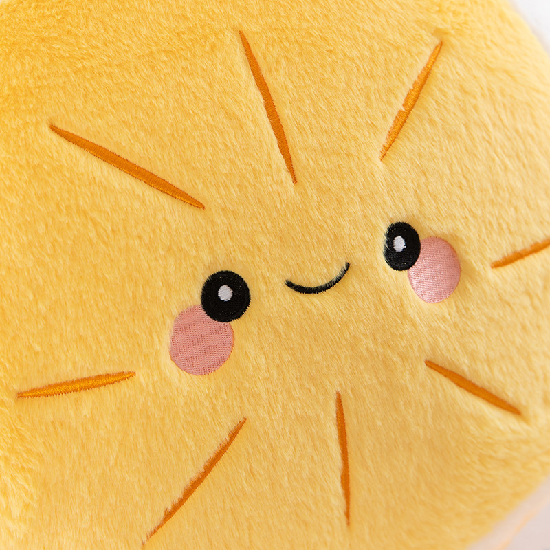 Close-up of orange plush pillow with embroidered smiling face and soft surface, cute fruit design for cozy home decor