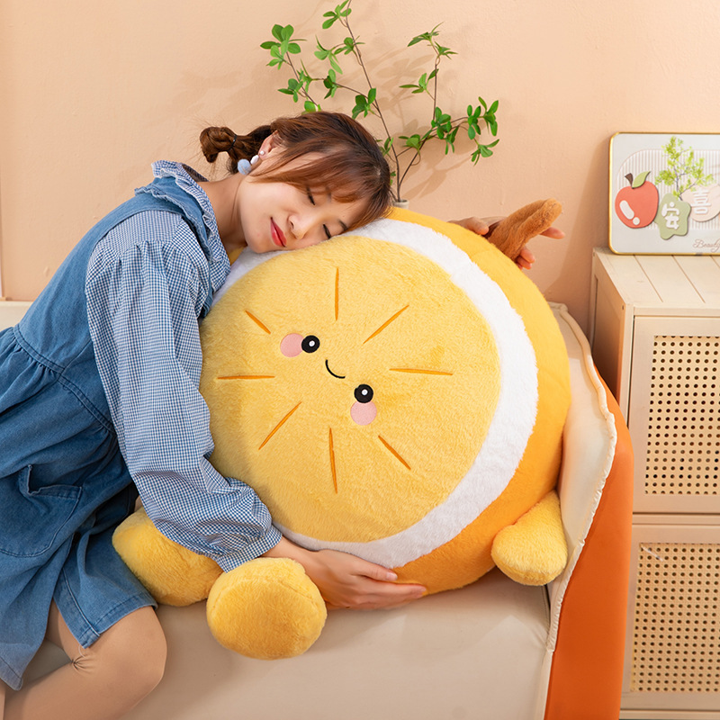 Orange plush pillow with a smiling face used for hugging on a sofa, soft and cozy cushion for relaxing, lounging, or napping at home