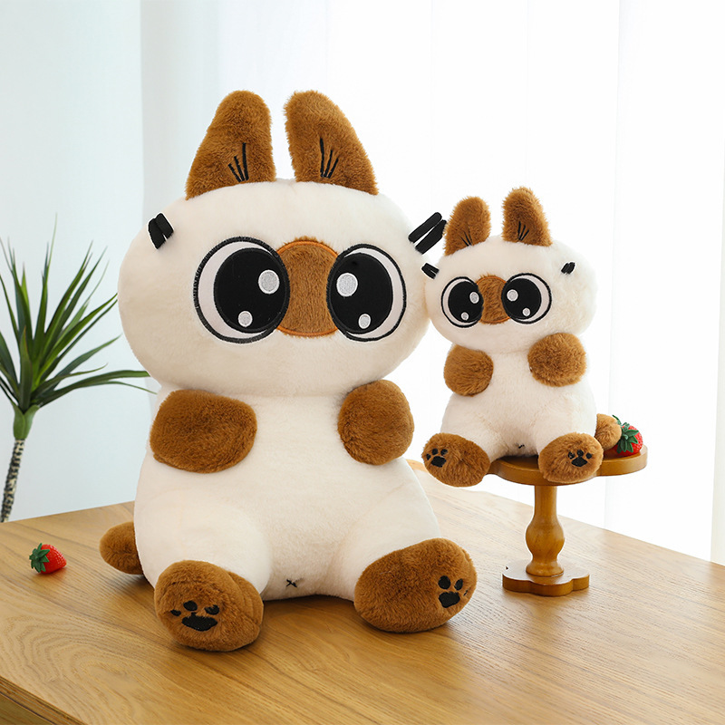Siamese cat plush toy in two sizes with soft plush fabric and big-eyed design, displayed on a table for cozy home decor and cuddling