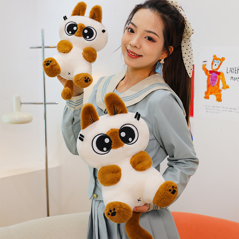 Siamese cat plush toy with big eyes and soft plush texture, shown in a cozy indoor setting, perfect for hugging and everyday comfort