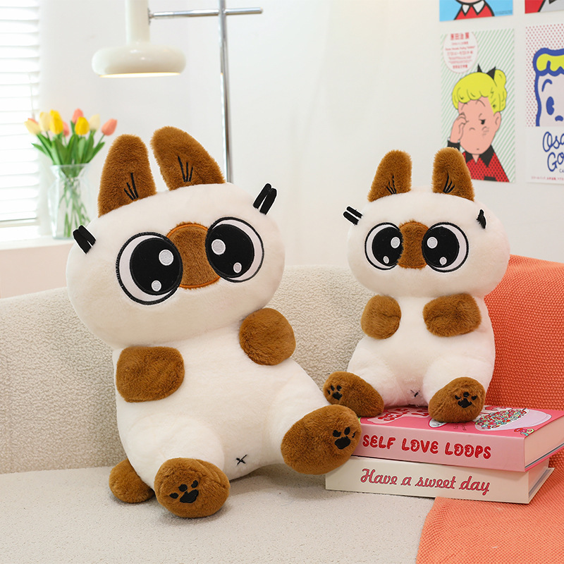 Siamese cat plush toy in different sizes placed on a sofa with soft stuffed texture, ideal for home decor and relaxing comfort