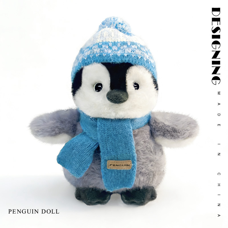Blue winter penguin plush toy with knitted hat and scarf soft stuffed animal front view product image