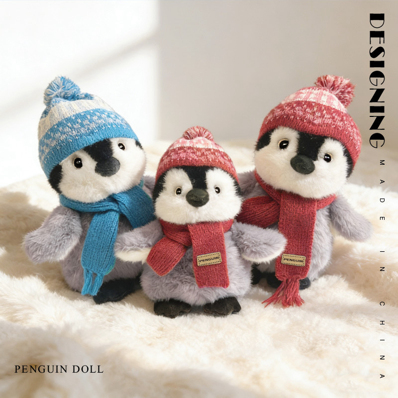 Cute winter penguin plush toys with scarf on soft blanket cozy stuffed animals home decor display