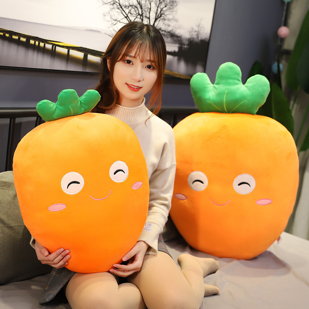 Carrot plush pillow with soft plush fabric and smiling face design, used as a cozy hugging cushion on bed or sofa