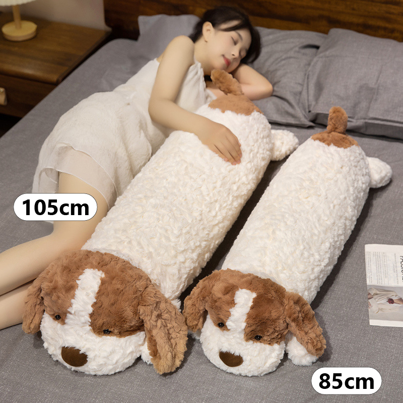 Lying dog long plush pillow size comparison showing 85 cm and 105 cm options, soft body cushion for hugging, sleeping and bed use