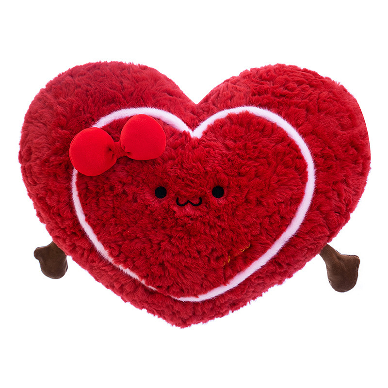 Heart plush pillow on white background, soft red heart-shaped cushion with cute design and fluffy texture