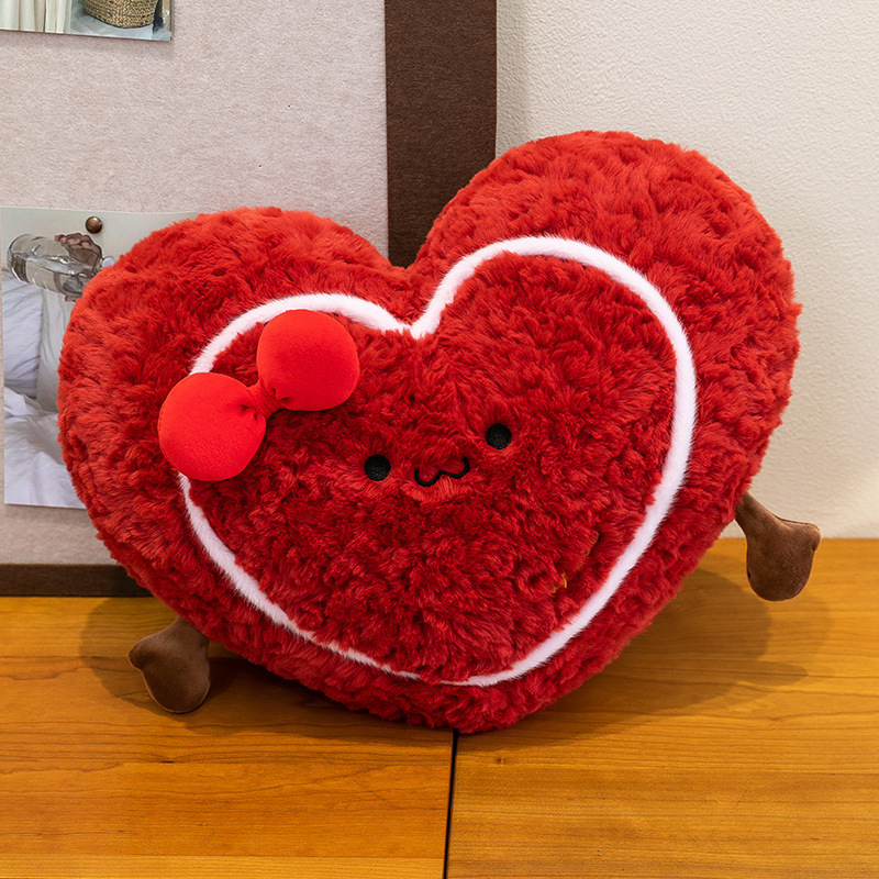 Heart plush pillow on a wooden table, fluffy red heart cushion with cute design for home decoration and relaxing comfort