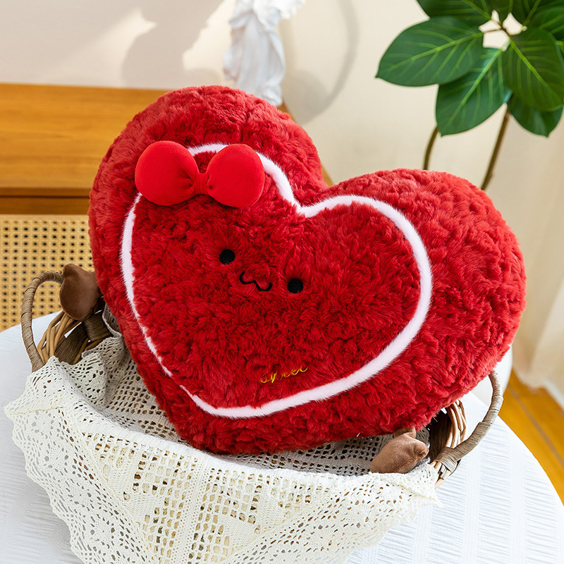 Heart plush pillow in a woven basket, soft red heart-shaped cushion styled for cozy home decor and warm bedroom atmosphere