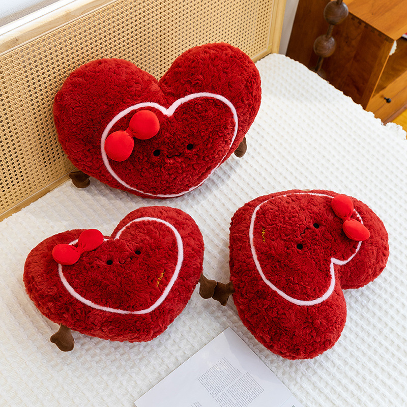 Heart plush pillows placed on a bed, soft and cozy cushions ideal for relaxing, decorating, and adding warmth to home spaces