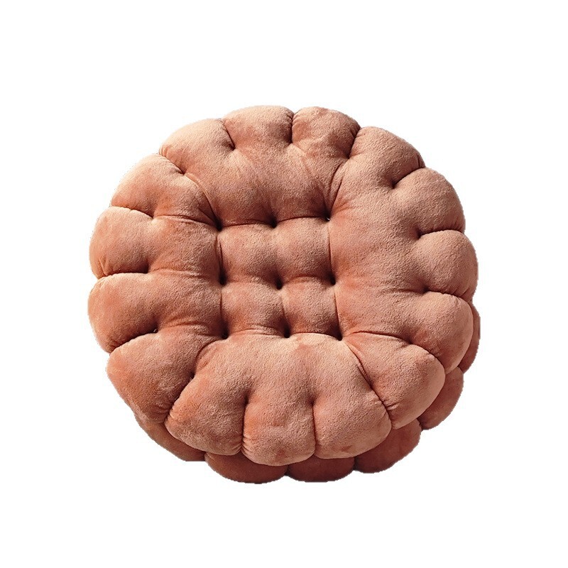 Brown sandwich cookie plush cushion isolated on white background, soft biscuit floor pillow for seating and home decor