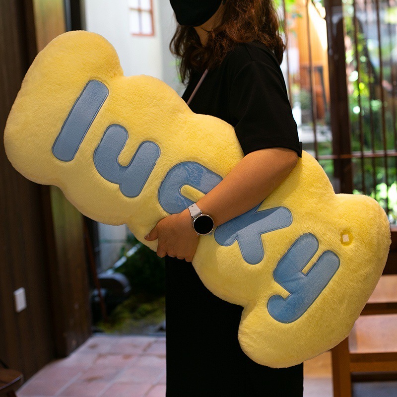 Yellow lucky plush pillow long soft cushion with smooth plush fabric, perfect for hugging and cozy relaxation