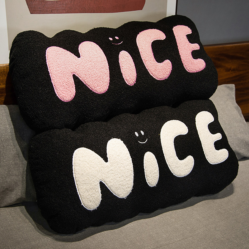 Nice plush pillow black with pink and white lettering soft long cushion stacked on bed cozy decorative support for bedroom