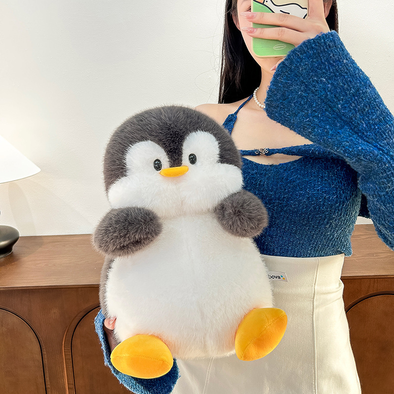 Cute penguin plush toy with soft plush fabric and rounded design, cuddly stuffed animal for hugging, decor or gifting