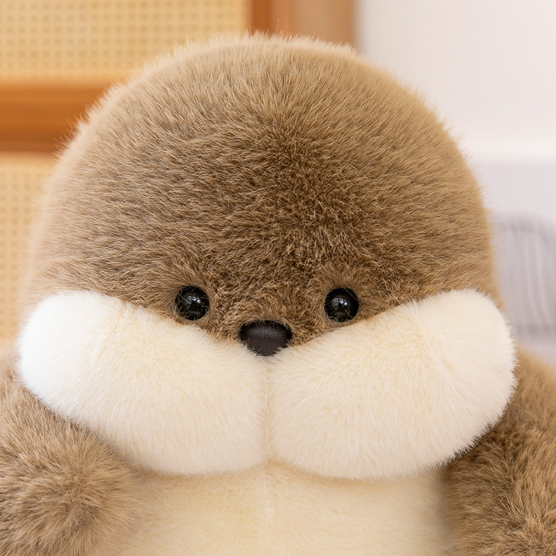 Close up of seal plush toy face with ultra soft fluffy texture and detailed stitching, high quality stuffed animal design