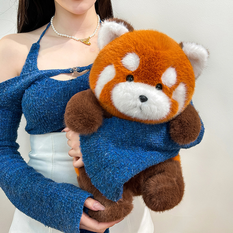 Red panda plush toy held in arms, ultra soft cuddly stuffed animal perfect for hugging, relaxation and comforting home decor