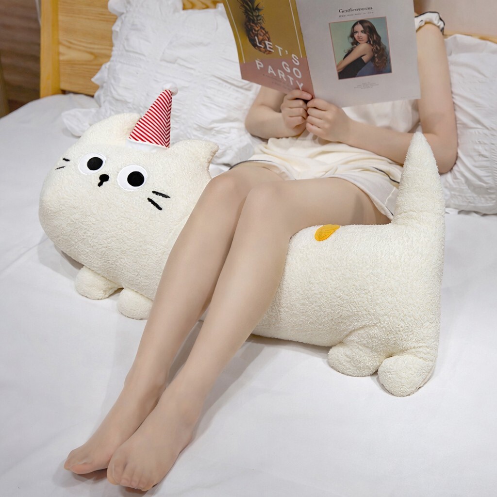 Big-eyed cat plush pillow in white, soft long body cushion for leg support and relaxation, perfect for lounging and reading in bed