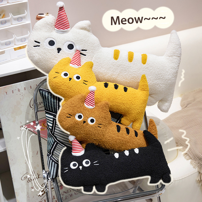Big-eyed cat plush pillow in multiple colors displayed on chair, soft long body cushion for hugging and relaxing, cozy home decor setting