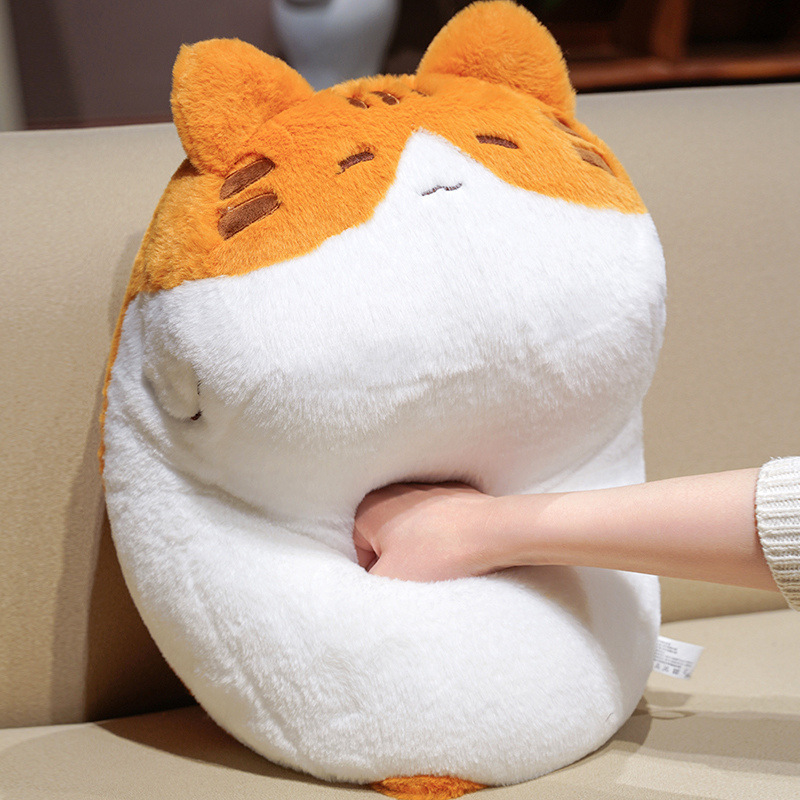Orange cat plush pillow being gently squeezed to show its soft fluffy texture and plush filling, ideal for hugging, relaxing, and stress relief