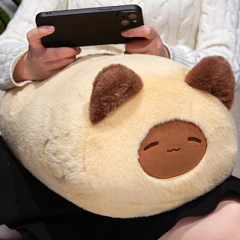 Siamese cat plush pillow resting on lap with soft plush surface and rounded form, perfect for relaxing, napping, or casual home comfort