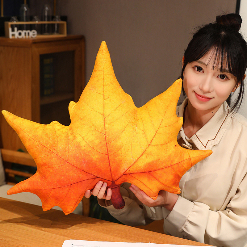Sycamore leaf plush pillow in orange gradient color, soft and realistic leaf texture, ideal for hugging and cozy home decor