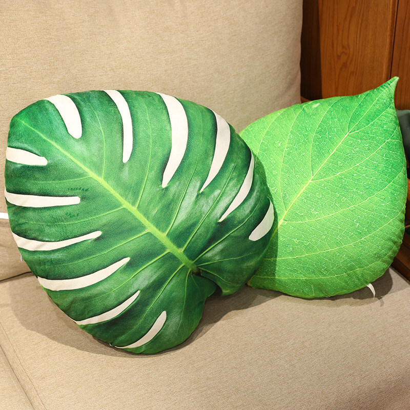 Leaf plush pillows in monstera and green leaf designs, soft plush cushions with realistic patterns for cozy home styling