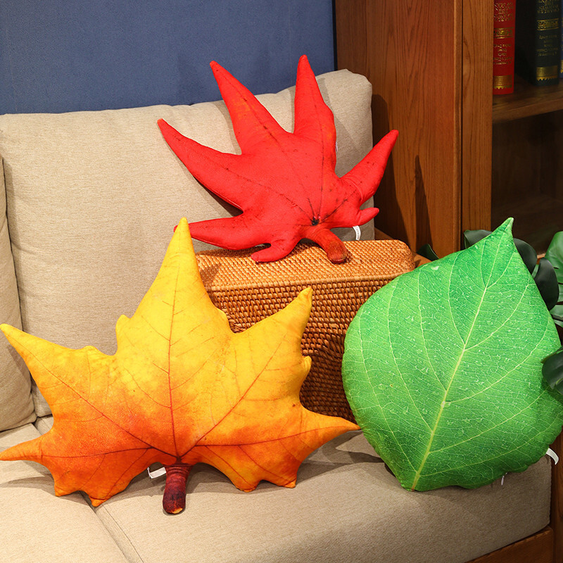 Leaf plush pillows in red maple, sycamore, and green leaf designs displayed on a sofa, soft and decorative for cozy home styling