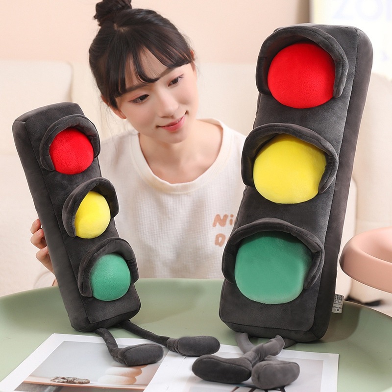 Close up of traffic light plush pillow showing soft plush fabric and colorful signal lights, long cushion toy with cute legs for relaxing and decor