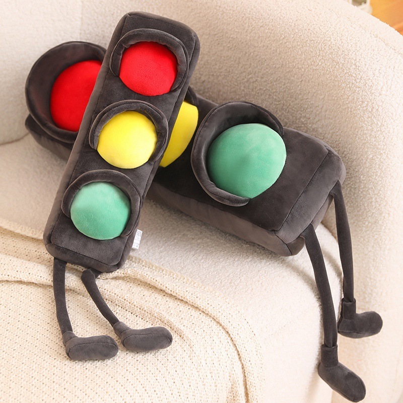 Traffic light plush pillows casually placed on a sofa, long soft cushions with colorful red yellow green lights, cozy plush pillows for relaxing and home decor